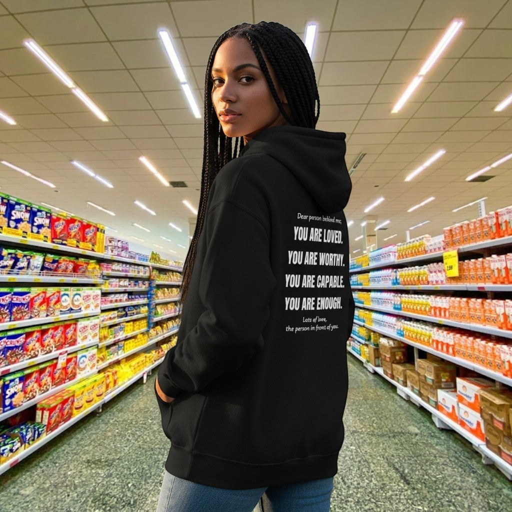 spiritualsavagee schwarzer Unisex-Hoodie mit inspirierendem Text-Rückendruck, getragen von einer Frau im Park.